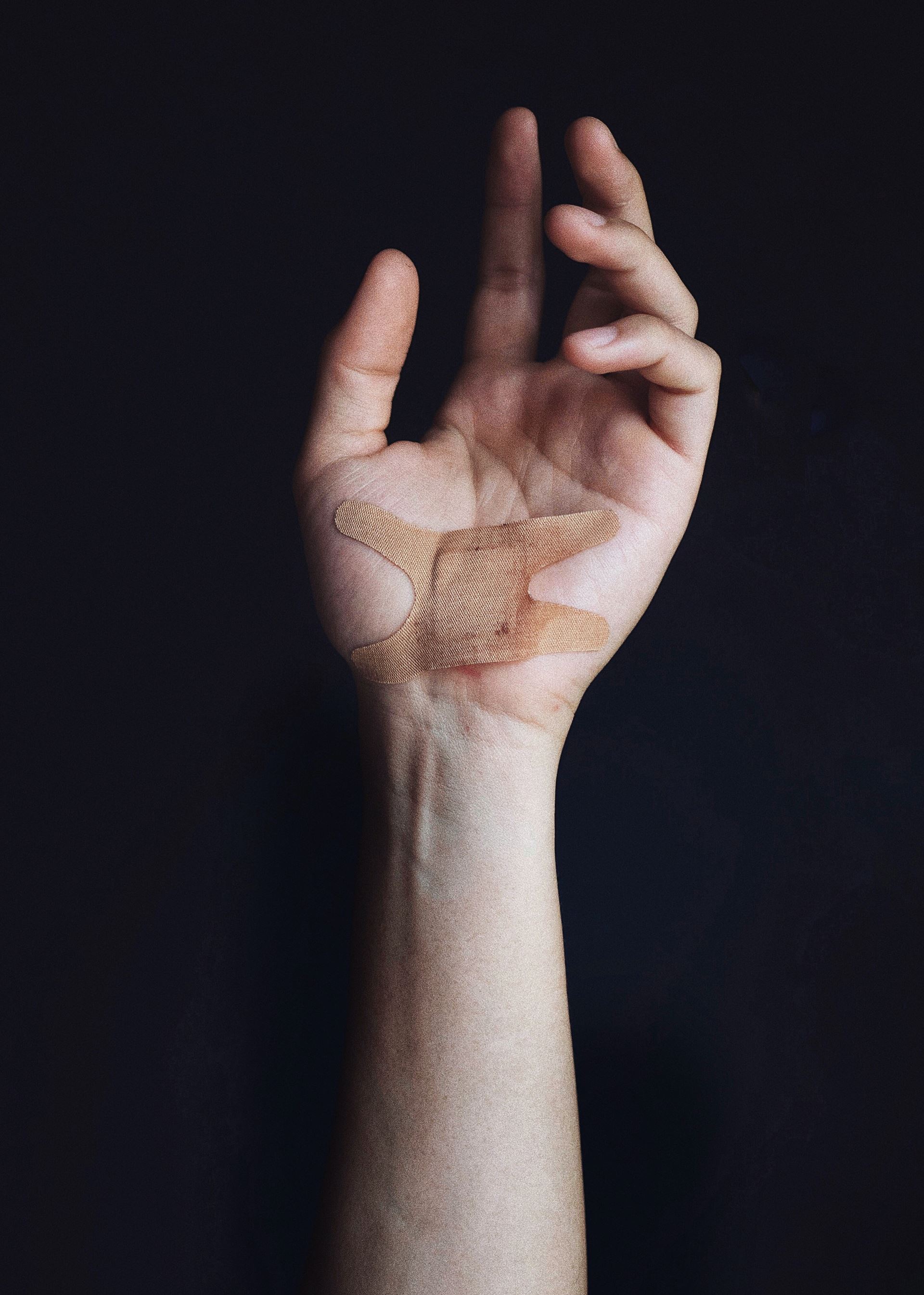 Hand with a plaster on it